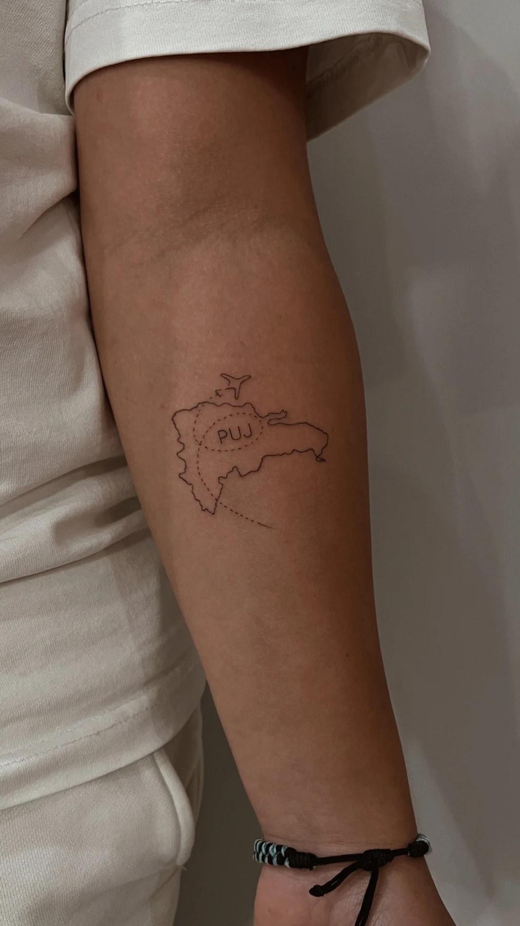 Small Dominican Republic map tattoo with PUJ lettering by Anastasia